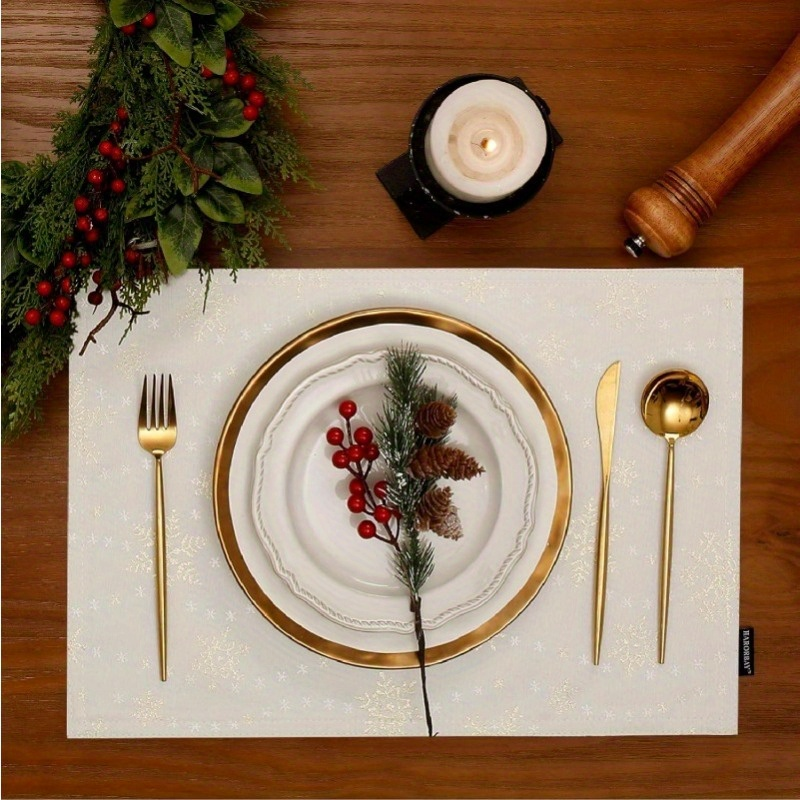 4-piece white placemats with gold snowflake pattern