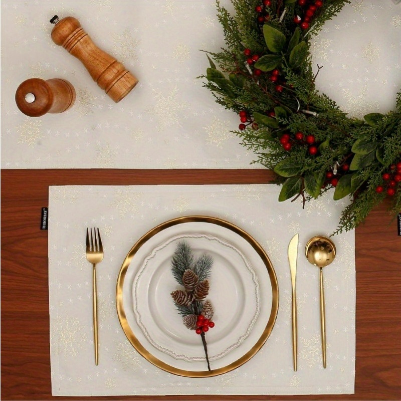 4-piece white placemats with gold snowflake pattern